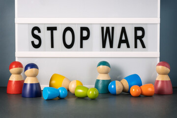 Anti-war concept. Stop war inscription and wooden figurines.