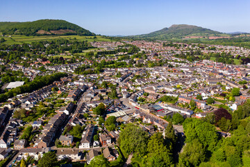 Aerial view of the Welsh town of Abergavenny surrounded by green fields and hills