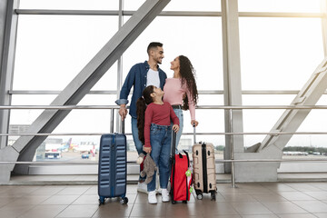 Traveling Together. Happy Arab Family Of Three Waiting Flight At Airport