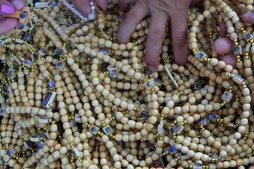 Hands touching rosaries during the festivities of Círio de Nazaré, the largest Marian procession...