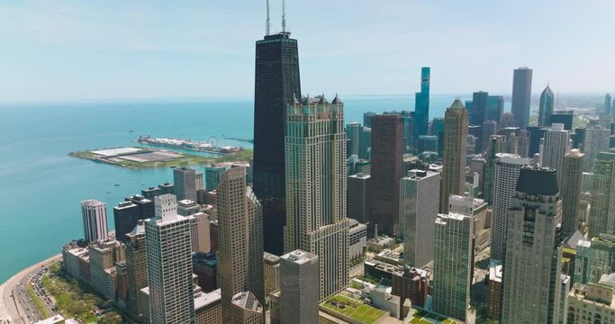Beautiful skyscrapers of Chicago standing on the waterfront of Lake Michigan. Aerial view of the buildings at the backdrop of blue water and sky.