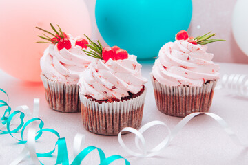 Dessert with pink cupcakes and air balloons on background, card with sweet food
