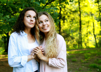 Mother With Adult Daughter In Park Together. Love and happy.