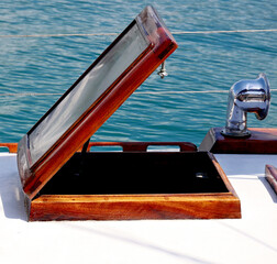 An open hatch on the deck of an old wooden boat