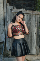 Fototapeta premium Sexy Latina poses in a sheer top and black skirt