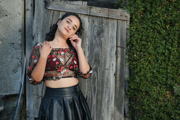 Fototapeta premium Sexy Latina poses in a sheer top and black skirt
