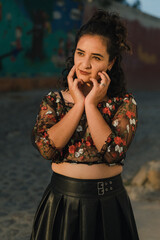 Obraz premium Pretty Latina poses in a see-thru top with a red bra
