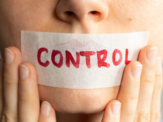 Control your tongue. Female holding plastered tape and covering her lips. Power of words, freedom...