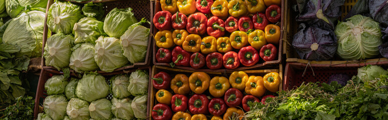Large market stall full of organic vegetables in the local food market