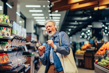 Senior man having fun while shopping in supermarket