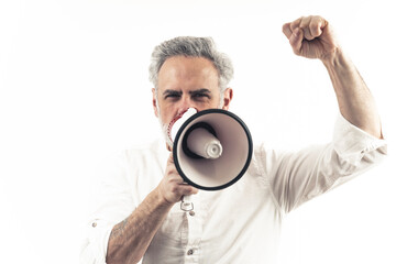 Closeup studio portrait with white background of a caucasian middle-aged silver-haired man using loudspeaker and showing his fist. Copy space. High quality photo