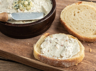 Gorgonzola cheese dip with sliced bread. Blue cheese cream