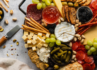 Close up of charcuterie board of cheese, meat, crackers and fruit. - Powered by Adobe