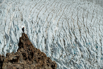 A lone hiker takes in the view of Glacier Piedras Blancas