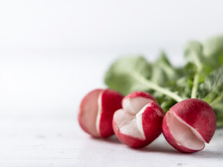 Cracked radish on a white wooden surface