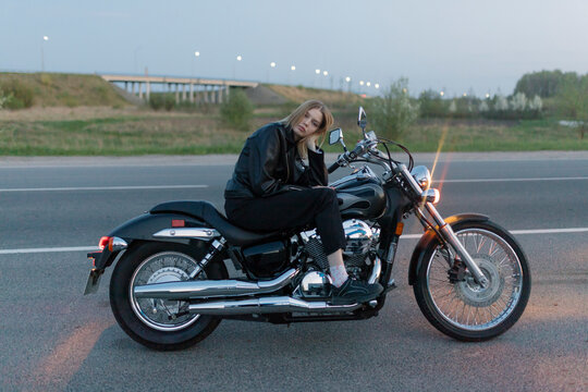 Blonde Woman Sitting On A Motorbike Alone