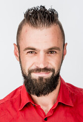 funny guy with a beard in a red shirt close-up shows different emotions. cheerful kind sad surprised satisfied range of emotions