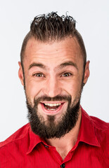 Obraz premium funny guy with a beard in a red shirt close-up shows different emotions. cheerful kind sad surprised satisfied range of emotions