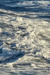 Waves with foam splasing in sea water