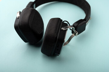 Fototapeta na wymiar black headphones on a mint background. Music concept.