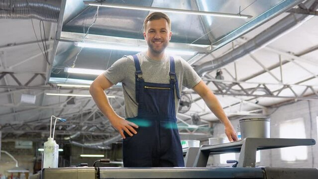 Portrait of an engineer on a printing factory. Industrial printing of posters, newspapers, leaflets, magazines