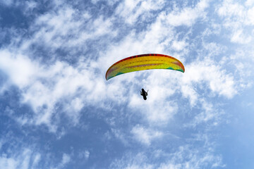 A paraglider in the sky over the Puy de Dome Volcanoes Regional Park of Auvergne, France.