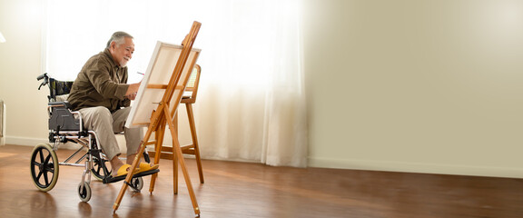 disabled artist senior male drawing sitting on wheel chair at home.small business,entrepreneurship...