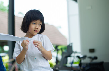 Children folding rocket, happy kid carrying paper airplane
