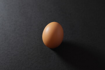 An illuminated egg on the left side and on a black background