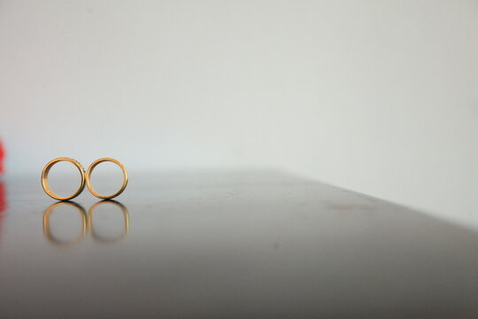 two wedding rings on a table
