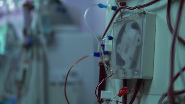 Close up doctor hand uses a dialysis machine for the patient