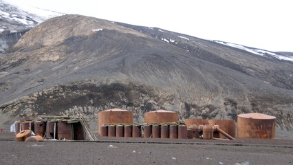 Row of rusted whale oil tanks and boilers used to rend whale oil at Whaler's Bay, on Deception...