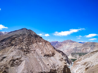 A flat riverbed between mountains in Valley, India.