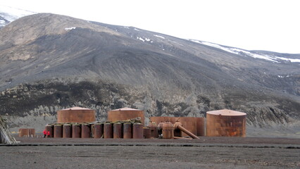 Row of rusted whale oil tanks and boilers used to rend whale oil at Whaler's Bay, on Deception...