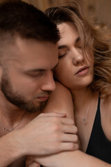 Beautiful young couple is completely immersed in enjoyment of intimacy with each other . Love emotions. Safe sex. Beauty and youth. Romantic date. Gentle hugs. Unforgettable experience.