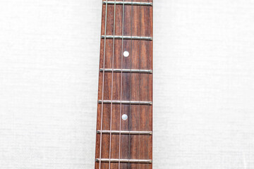 Neck of electric guitar with guitar fretboard.