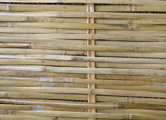 Bamboo that is cut into ribs and weaves it to make a wall.