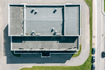flat shingle roof of industrial building with ventilation systems. aerial top view - 506979137