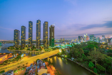 Aerial view of Bitexco Tower, buildings, roads, Thu Thiem 2 bridge and Saigon river in Ho Chi Minh city - Far away is Landmark 81 skyscraper. Travel concept.