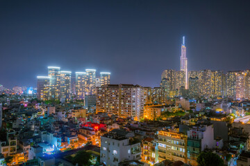 Aerial view of Bitexco Tower, buildings, roads, Thu Thiem 2 bridge and Saigon river in Ho Chi Minh city - Far away is Landmark 81 skyscraper. Travel concept.