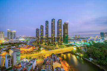 Aerial view of Bitexco Tower, buildings, roads, Thu Thiem 2 bridge and Saigon river in Ho Chi Minh...