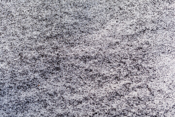 Obraz premium Black soot from the boiler room on white snow. Natural background. Snow mixed with coal soot, poor ecology. Environmental pollution 