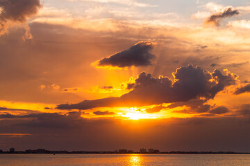 Sunset at sea golden sky sunlight and clouds at the beach