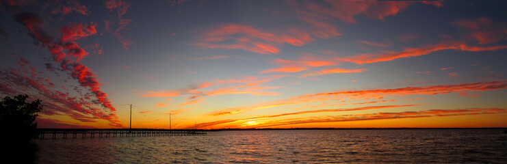 Fototapeta premium River sunset clouds dock panorama