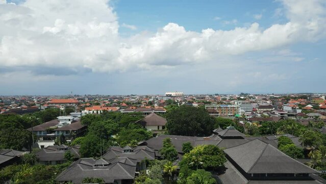 Aerial View of Legian, Kuta, Bali Island, Indonesia. Buildings and Tropical Lush Under Beautiful Sky, Drone Shot