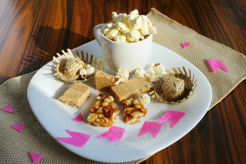 Typical food of June party Brazil, peanuts candy and popcorn with straw hats and paper flags.