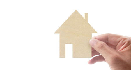 Hands holding paper house, family home