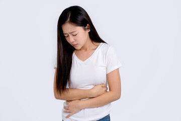 A woman holds on to her stomach during her period. Stomachache. Menstrual pain.