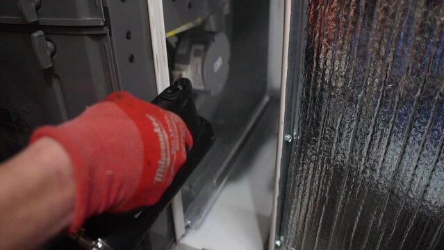 Slow motion close up showing disinfecting mist blowing into household air conditioning filter compartment