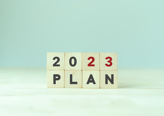 2023 business plan and strategies. Goal, plan, action. Annual plan and development for achieving golas. Goal acheiveement and success in 2023. Woden cubes written 2023 and plan on smart background.